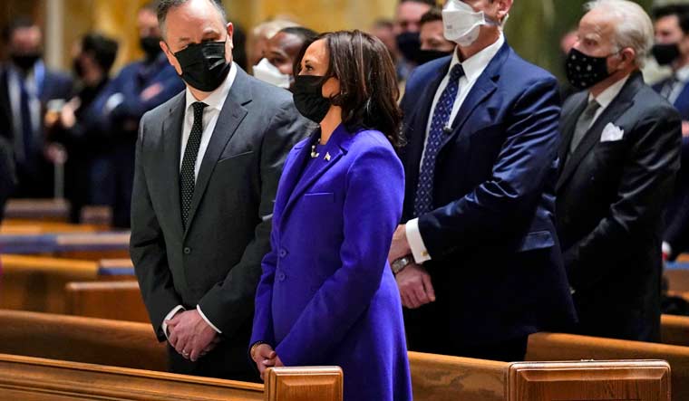 Doug Emhoff looks at his wife Vice President-elect Kamala Harris as they attend Mass at the Cathedral of St. Matthew the Apostle during Inauguration Day ceremonies Wednesday, Jan. 20, 2021, in Washington | AP Photo/Evan Vucci
