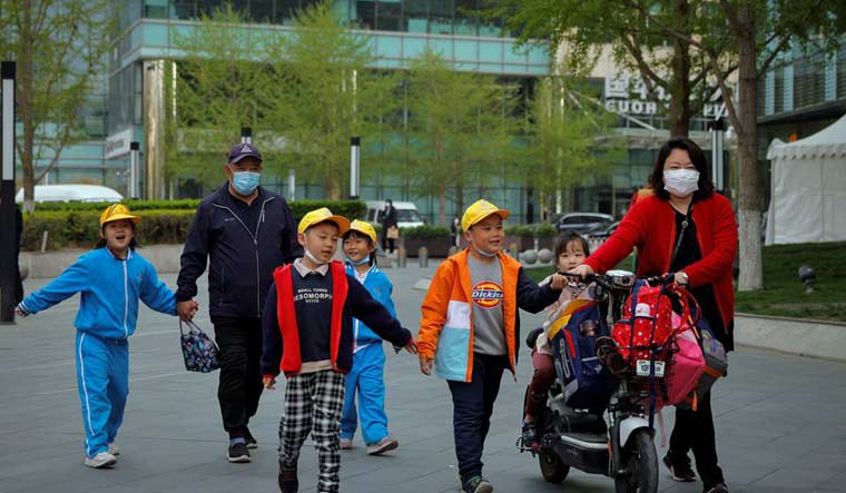 People pick up children from a school in Beijing, China, April 6, 2021 | Reuters