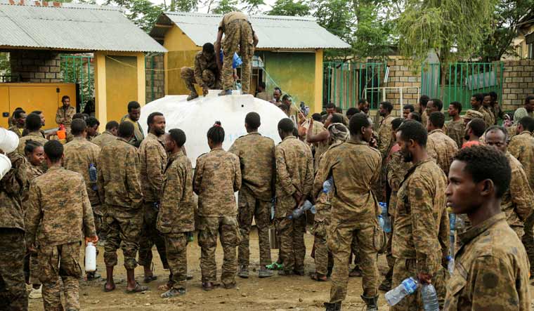 Captive Ethiopian army soldiers get their water ration in a prison in the outskirts of Mekelle, the capital of Tigray region, Ethiopia, July 7, 2021 | Reuters