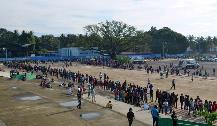 Migrants, mostly Haitians, wait in line for asylum processing by Mexico's Commission for Refugee Assistance (COMAR) outside a soccer stadium in Tapachula, Mexico October 18, 2021 | REUTERS
