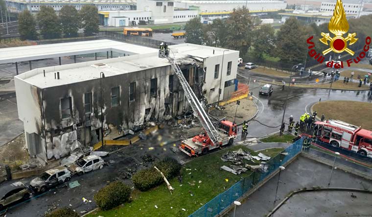 Firefighters work on the site of a plane crash, in San Donato Milanese suburb of Milan, Italy | AP/PTI