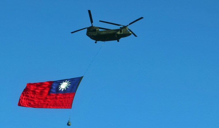 A Taiwan flag is carried across the sky during a national day rehearsal in Taipei, Taiwan | Reuters