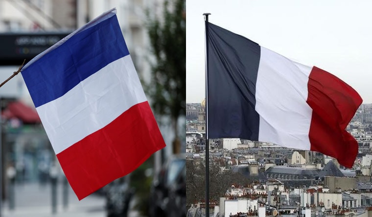 L-R: The old French flag with a bright blue, right the new flag with navy blue | Reuters