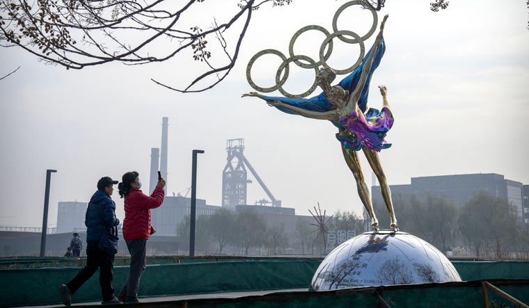 Visitors at a park near the headquarters of the Beijing Organising Committee for the Olympic Games | AP