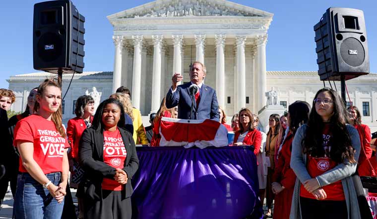 Texas Attorney General Ken Paxton speaks to a crowd of anti-abortion supporters outside the US Supreme Court following arguments over a challenge to a Texas law that bans abortion after six weeks in Washington, US, November 1, 2021 | Reuters