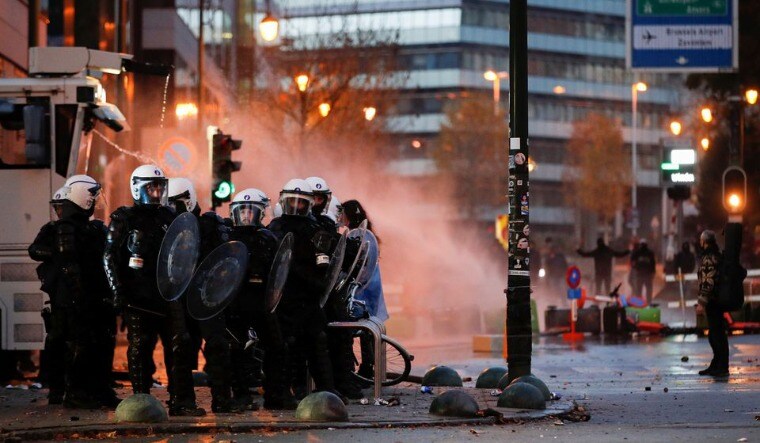 Police forces stand guard as people protest against COVID-19 measures near the European Commission in Brussels, Belgium November 21, 2021 | Reuters