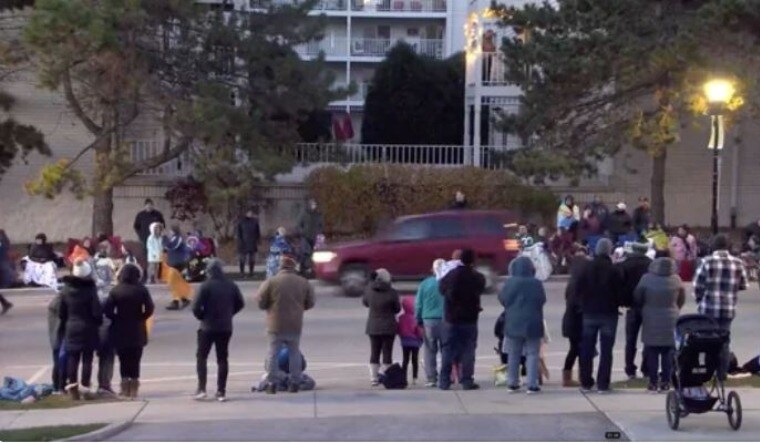 A red SUV speeds past attendees moments before plowing into a crowd at a Christmas parade in Waukesha, Wisconsin | Reuters