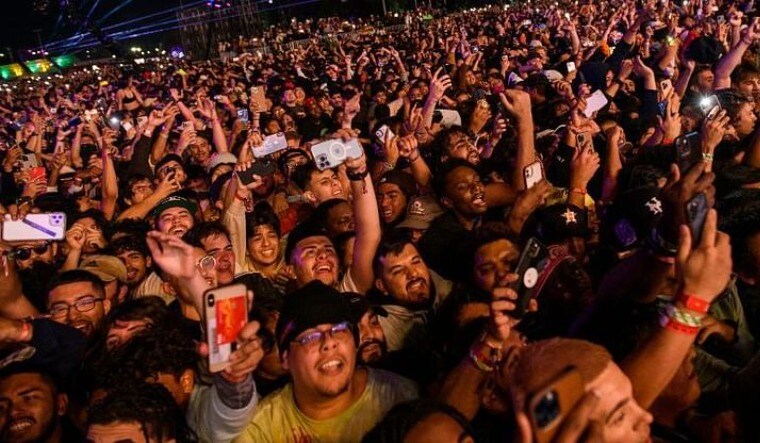 The crowd watches as Travis Scott performs at Astroworld Festival at NRG park on Nov. 5, 2021 in Houston | AP
