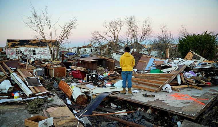 A man stands amongst the rubble of the home he grew up in after a devastating outbreak of tornadoes ripped through several U.S. states, in Mayfield, Kentucky, US December 13, 2021 | Reuters