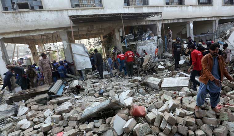 Pakistani security personnel and rescuers inspect the scene of a gas explosion in Karachi, Pakistan, Saturday, Dec. 18, 2021 | AP