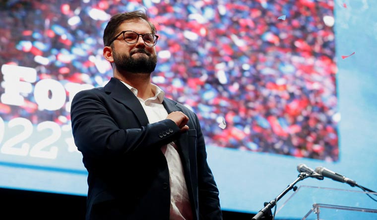Gabriel Boric gestures as he celebrates with supporters in Santiago after winning the presidential election | Reuters