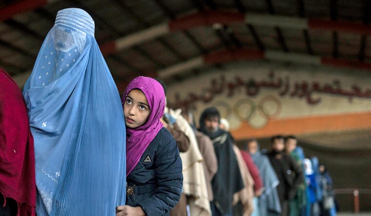 Women queue to receive cash at a money distribution organised by the World Food Program in Kabul, Afghanistan, on Saturday, Nov. 20, 2021 | AP
