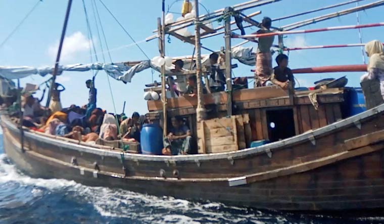 A boat carries Rohingya people stranded at sea, Indonesia, December 27, 2021 | Reuters