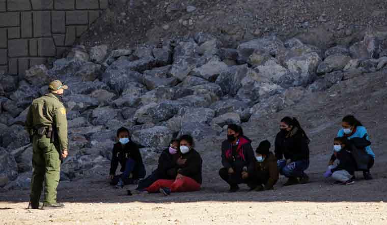 [File] Migrants are detained by a US Border Patrol agent as they turn themselves in to request asylum, after crossing into El Paso, Texas, US, as seen from Ciudad Juarez, Mexico | Reuters