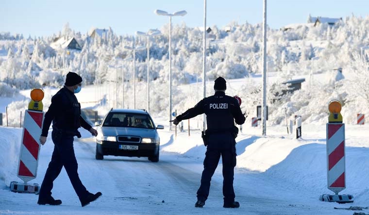 German border police officers stop a car at the border as controls between Germany and the Czech Republic have been re-established | Reuters