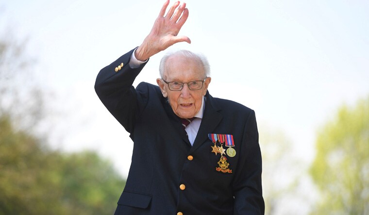 (File) Captain Tom Moore waves after achieving his goal of 100 laps of his garden, at his home in Marston Moretaine, England | AP
