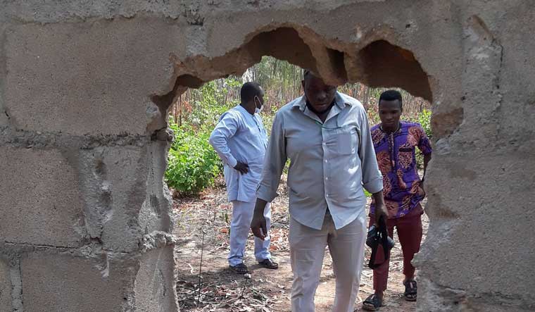 People are seen at the broken perimeter fence through which gunmen gained access the male and female hostels at the Federal College of Forestry and Mechanisation in Kaduna, Nigeria March 12, 2021 | Reuters
