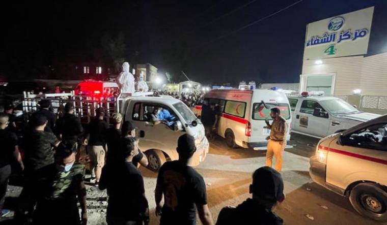 People gather outside the hospital in Baghdad where the fire broke in the Intensive Care Unit | Reuters