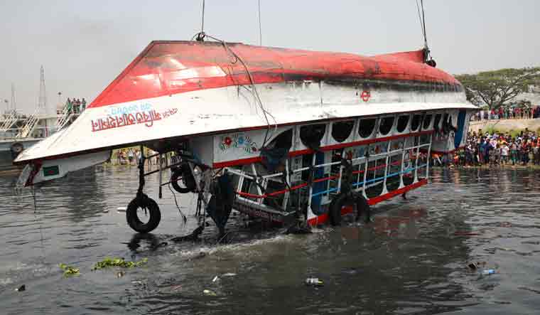The ferry that collided with a cargo vessel and sank on Sunday in the Shitalakhsyaa River is pulled out from the river with a crane, during rescue operations in Narayanganj, Bangladesh, April 5, 2021 | REUTERS/Mohammad Ponir Hossain
