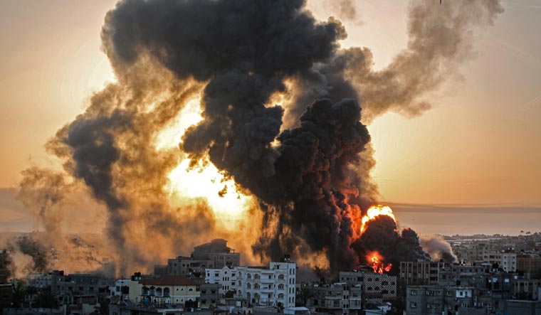 Fire rages at sunrise in Khan Yunish following an Israeli airstrike on targets in the southern Gaza strip | AFP