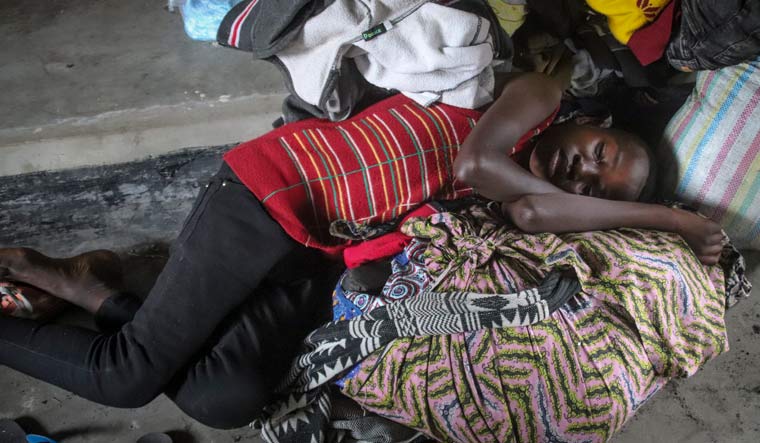A displaced girl sleeps in a church where she is taking shelter in the town of Sake, northwest of Goma, in eastern Congo Friday, May 28, 2021 | AP 