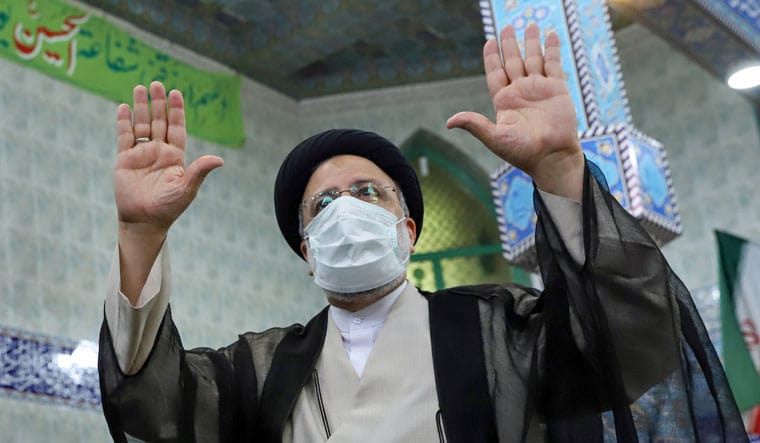 Presidential candidate Ebrahim Raisi gestures after casting his vote during presidential elections at a polling station in Tehran, Iran June 18, 2021 | Reuters