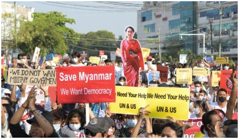 Demonstrators hold placards and a cutout with the image of Aung San Suu Kyi during a protest against the military coup in Yangon, Myanmar, February 15, 2021 | Reuters