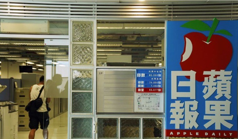 An employee walks at the offices of Apple Daily and Next Media after police raided the newsroom, in Hong Kong, China June 17, 2021 | Reuters