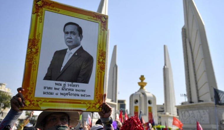 A pro-democracy demonstrator holds a portrait of Thai Prime Minister Prayuth Chan-ocha, at a gathering at Democracy Monument in Bangkok, Thailand, March 7, 2021 | Reuters