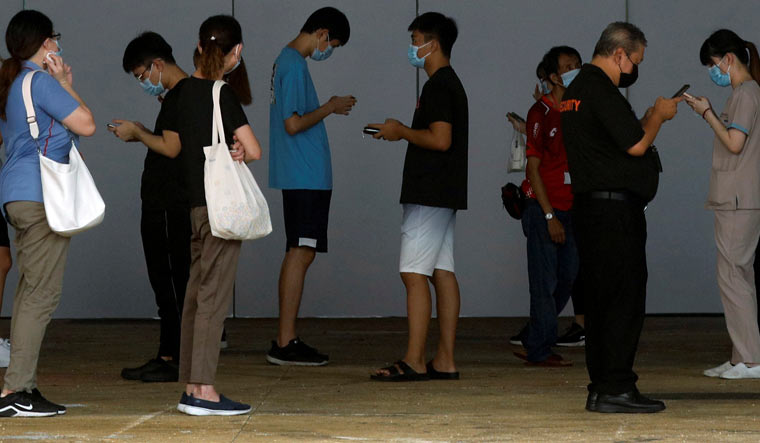 People waiting to undergo swab tests in Singapore | Reuters