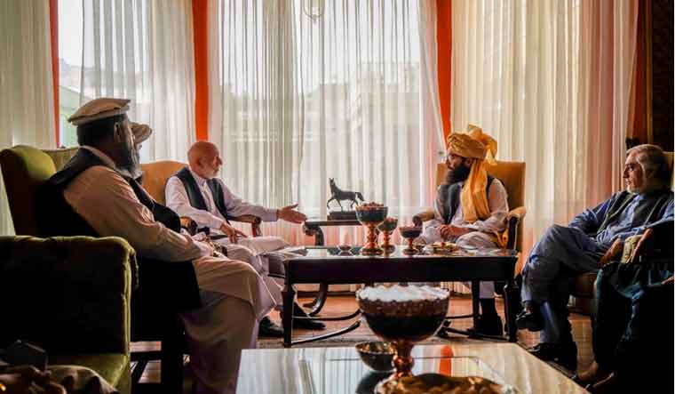In this handout photograph released by the Taliban, former Afghan President Hamid Karzai [center left], senior Haqqani group leader Anas Haqqani [center right], and Abdullah Abdullah, head of Afghanistan's National Reconciliation Council and former government negotiator with the Taliban [right], meet in Kabul, Afghanistan on Wednesday, August 18, 2021 | AP