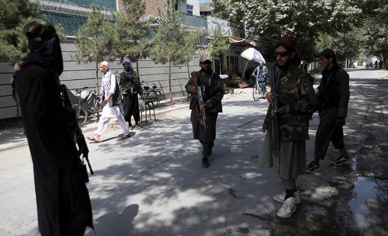 Taliban fighters stand guard at a checkpoint in the Wazir Akbar Khan neighborhood in the city of Kabul | AP