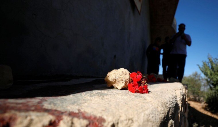 Palestinians check the scene where Hamas militants were killed by Israeli forces in a gun battle during a raid in Beit Anan in the Israeli-occupied West Bank September 26, 2021 | Reuters
