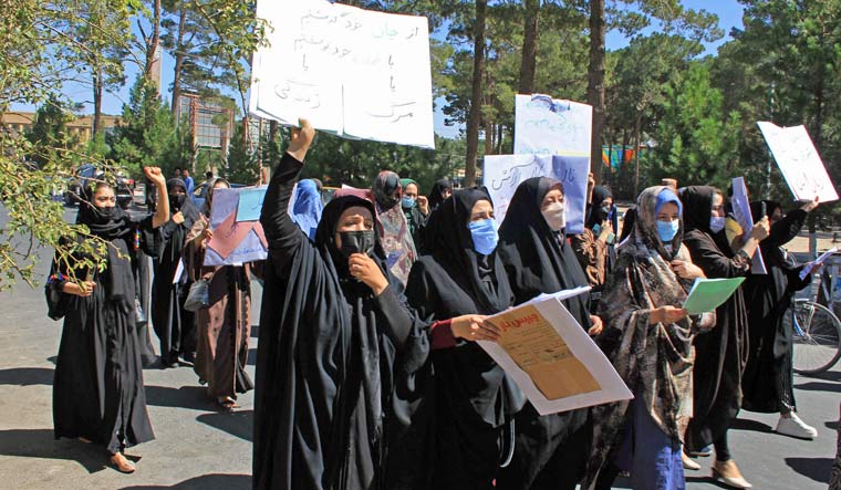 Afghan women hold placards as they take part in a protest in Herat on September 2, 2021 | AFP