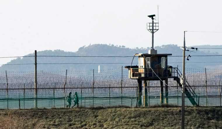 South Korean army soldiers patrol along the barbed-wire fence in Paju, near the border with North Korea, South Korea, Sunday, Jan. 2, 2022 | AP
