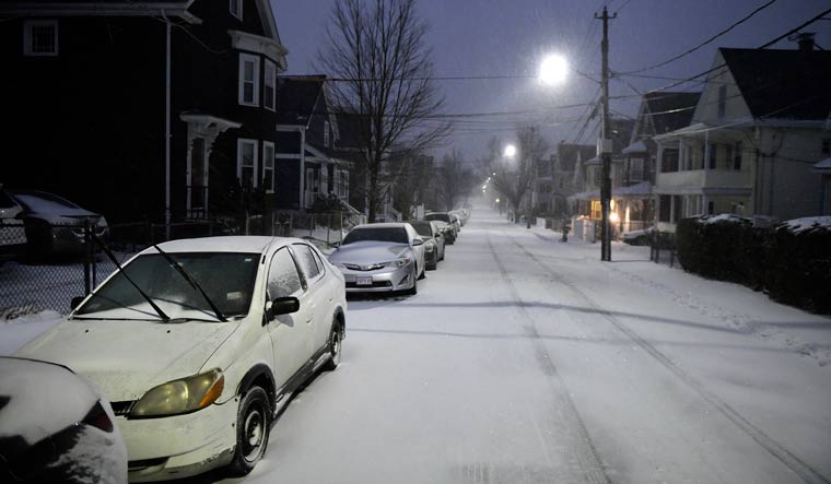 Dawn breaks as the beginning of a major snow storm arrives in Somerville | AP