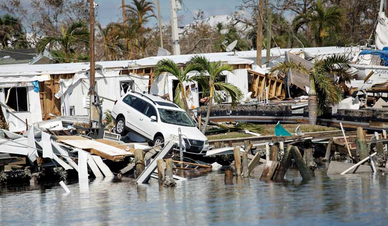 A destroyed car is seen in the Matanzas Pass after Hurricane Ian caused widespread destruction in Fort Myers Beach, Florida, U.S., October 1, 2022 | Reuters