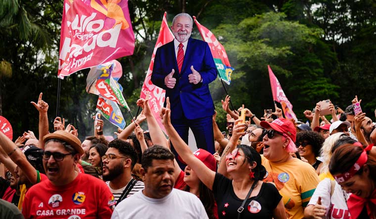 Supporters cheer during a campaign rally for former President Luiz Inacio Lula da Silva, pictured in a life-size cutout in the background, in Sao Paulo, Brazil, Saturday, Oct. 29, 2022 | AP