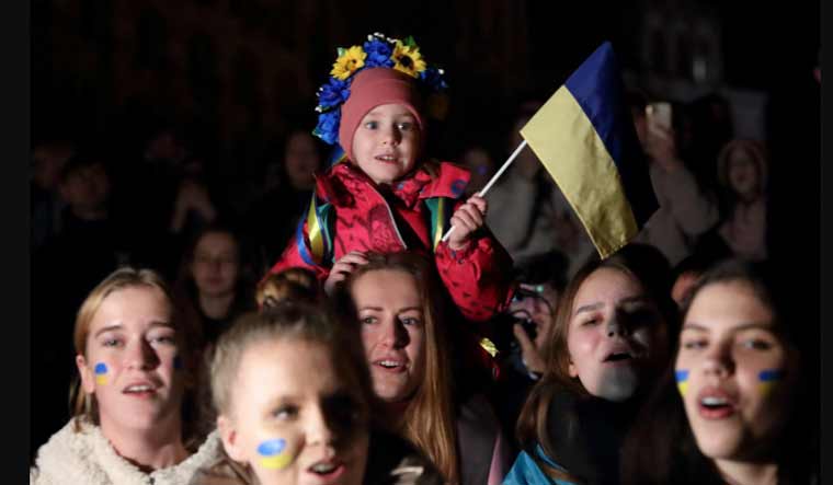 People celebrate after Russia's retreat from Kherson, in central Kyiv, Ukraine | Reuters
