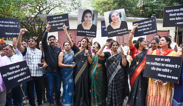 People hold placards as they shout slogans to protest against the killing of Shraddha Walker | PTI