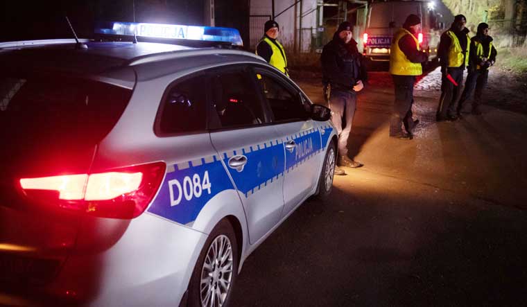Police officers gather outside a grain depot in Przewodow, eastern Poland, on Tuesday  where a Russian-made missile fell and killed two people | Reuters