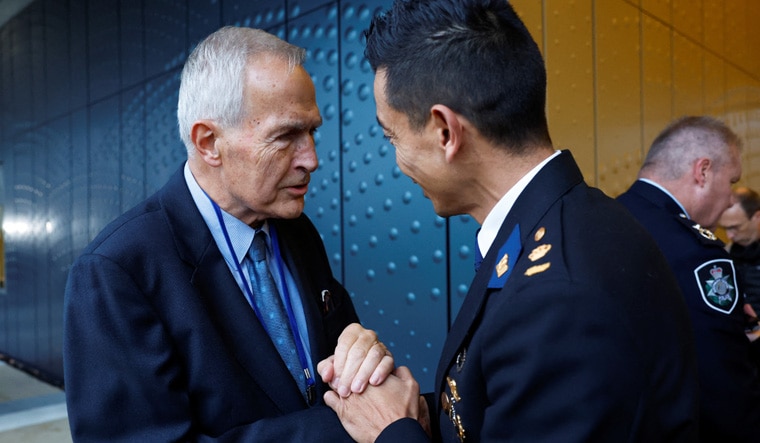 Anton Kotte, relative of victims of the Malaysia Airlines flight MH-17 crash, shakes hands with Andy Kraag, head of the National Criminal Investigations Division, after the Dutch court announced its ruling in the MH17 trial of three Russians and a Ukrainian in the Schiphol Judicial Complex, Badhoevedorp, Netherlands, November 17, 2022. REUTERS/Piroschka van de Wouw  