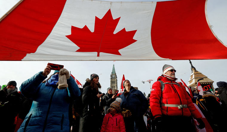 Demonstrators gather on Parliament Hill as truckers and their supporters continue to protest coronavirus disease (COVID-19) vaccine mandates, in Ottawa, Ontario, Canada, February 12, 2022 | Reuters
