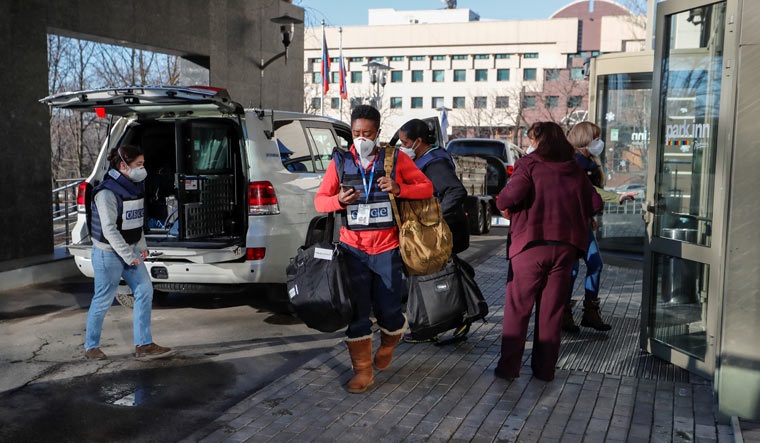 Members of the Organisation for Security and Co-operation in Europe (OSCE) leaving the Park Inn hotel housing the monitoring mission in Donetsk city | Reuters