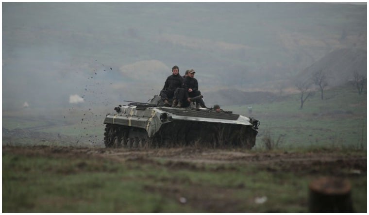Service members of the Ukrainian armed forces drive an armoured vehicle during a training at a firing range in Donetsk region, Ukraine April 20, 2021 | Reuters