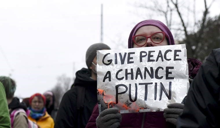 People hold a demonstration against Russia's invasion of Ukraine in front of the Russian embassy in Helsinki, Finland | Reuters