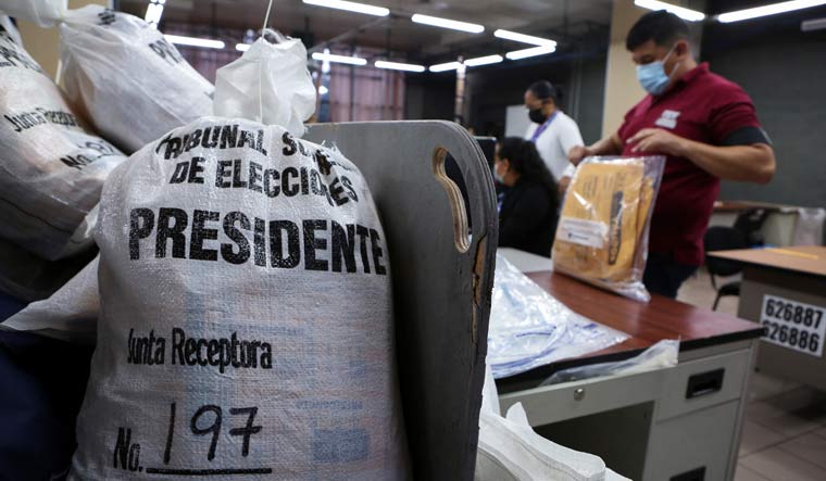 Sacks with ballots are pictured as employees of the Supreme Electoral Court open envelops to count votes during the first round of the presidential elections, in San Jose, Costa Rica | Reuters
