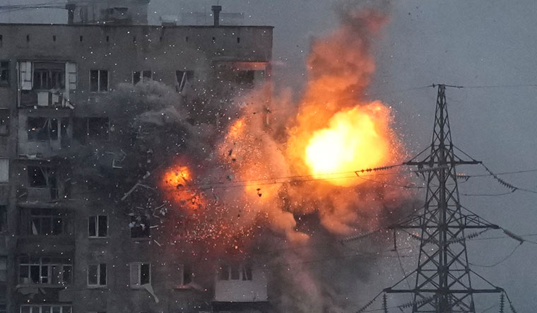 An explosion in an apartment building that came under fire from a Russian army tank in Mariupol | AP