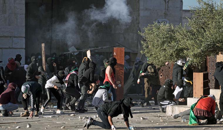 Palestinians clash with Israeli security forces at the Al Aqsa Mosque compound in Jerusalem's Old City Friday, April 15, 2022 | AP