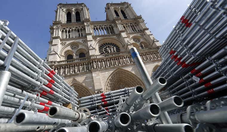 Scaffolding's parts stored are photographed outside Notre-Dame de Paris cathedral, in Paris, Friday, April 15, 2022 | AP